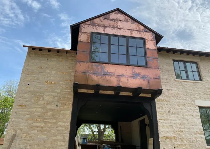 Copper metal panel facade on a stone building for Roof Repair in Medical Lake